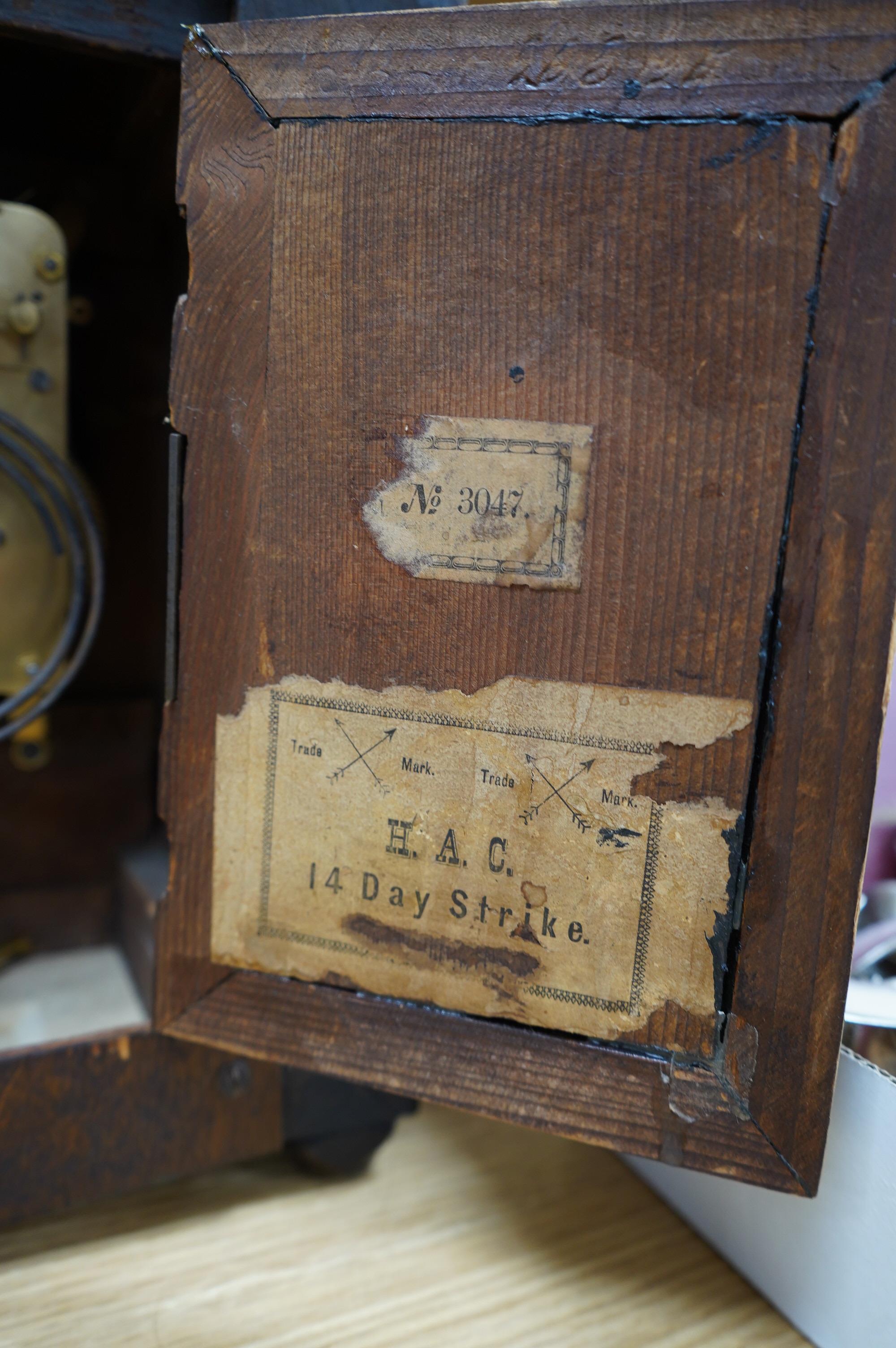 A late 19th century Black Forest walnut mantel clock with key and pendulum, 41cm. Condition - fair to good, not tested